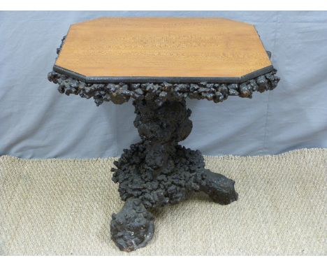 A 19thC satinwood table raised on an unusual burr wood base, probably a whole trunk of holly/cherry or similar, H70 x W73 x D