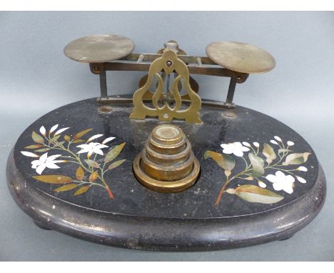 A late 19thC pietra dura postage scale with rates to pan and weights to base, width 29cm