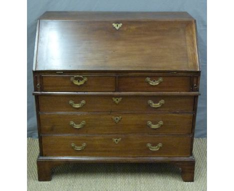 A Georgian mahogany bureau with four graduated drawers and fitted interior raised on bracket feet, H103 x W101 x D54cm