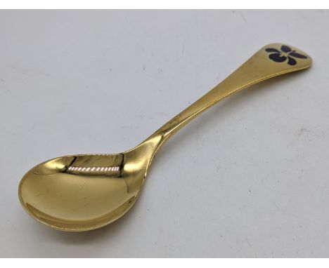 A Georg Jensen gilt silver annual 1977 spoon, violet enamel flower to terminal, Danish marks, 43g, L.17cm