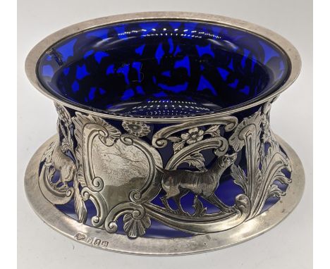 An Edwardian Irish silver potato ring, decorated with hounds, foxes, flowers and birds, cartouche engraved with a fish, hallm