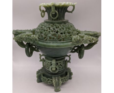 A Chinese spinach jade incense burner, handles in the form of dragon heads, pierced lid, raised on four dragon feet, H.25cm W