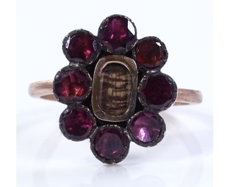 An unmarked gold flat-top garnet memorial ring, setting height 17.1mm, size P, 2.8g