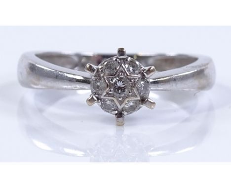 An 18ct white gold diamond cluster ring, total diamond content approx 0.15cts, setting height 7.5mm, size M, 2.8g