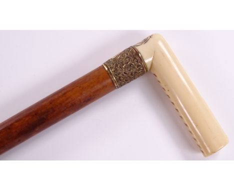 A 19th century carved ivory-handled walking stick, with gilt-metal mount