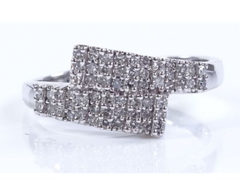 A 9ct white gold diamond pave cluster crossover ring, setting height 10.5mm, size O, 2.6g