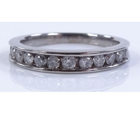 A 9ct white gold diamond set half eternity ring, total diamond content approx 0.5cts, setting height 3.5mm, size K1/2, 2.7g