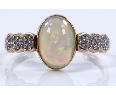 An unmarked gold opal and diamond dress rings, setting height 11.6mm, size T, 2.5g