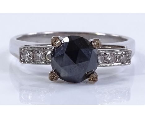 An unmarked white metal diamond line ring, central black rose-cut diamond approx 1ct, set with diamond shoulders, size L, 4.1