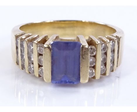 A 14ct gold blue-stone and diamond and cluster dress ring, central stone possibly iolite, setting height 7mm, size M, 6.2g