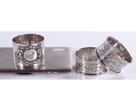 An engine-turned silver cigarette case, together with 3 silver napkin rings, 8.2oz total