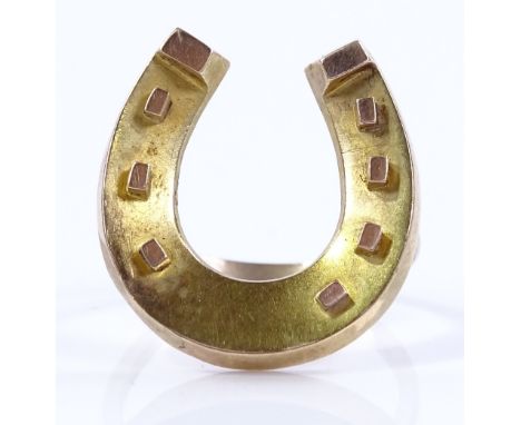 An unmarked gold horseshoe design ring, height 21.1mm, size O, 3g