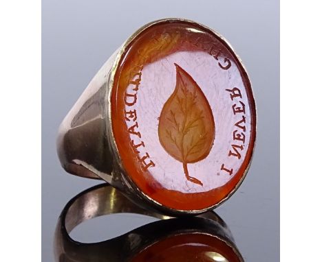 A 9ct gold Carnelian Intaglio seal ring, with leaf design and script "I never change til death", setting height 19.6mm, size 