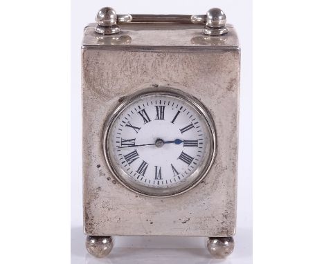 A silver-cased carriage clock, with swing handle and bun feet, hallmarks Chester 1897, height excluding handle 7.5cm