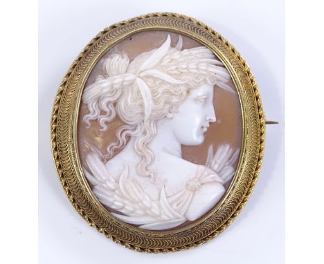 A relief carved cameo brooch, depicting a Classical female portrait, settings test as 15ct gold, brooch height 43.5mm, 10.6g