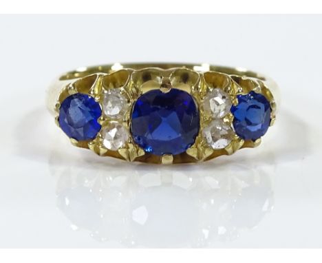 An 18ct gold 7-stone sapphire and diamond ring, setting height 7.4mm, size K, 3.5g