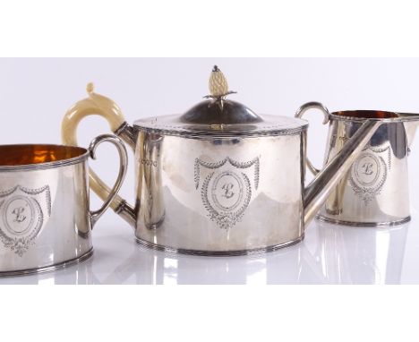 A Victorian silver oval-shaped 3-piece tea set, with gilded interior and ivory pineapple knop and handle, by Robert Harper, L