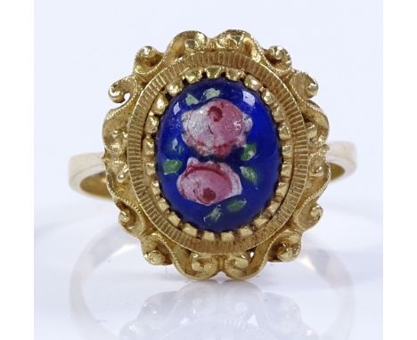 An unmarked gold and enamel panel ring, with scroll border and floral panel, tests as above 9ct gold, setting height 15.9mm, 