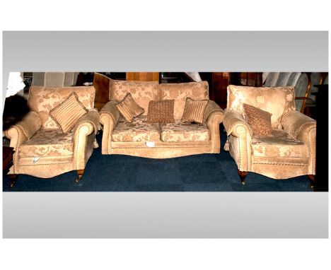 Modern Lounge Suite comprising two seater sofa and two single chairs. Upholstered in beige fabric with matching accessories. 