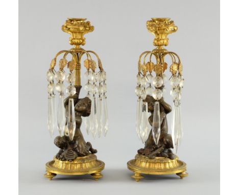 Pair of 19th century bronze cherub candle lustres on gilt metal stands, 28cm high