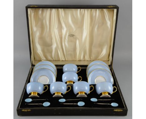 Set of six Grosvenor China coffee cups and saucers with blue and gilt decoration and six silver and blue enamelled coffee spo