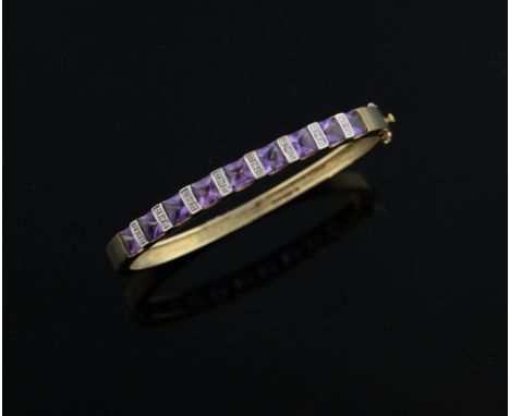 õ Amethyst set gold hinged bangle, the nine square cut stones interspersed with white gold bars set with small diamonds, 9ct 