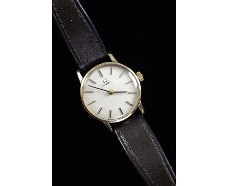 Ladies Omega 9ct yellow gold wristwatch, cream dial with hour markers. on a black strap. Manual wind movement. Circa 1973.Dia