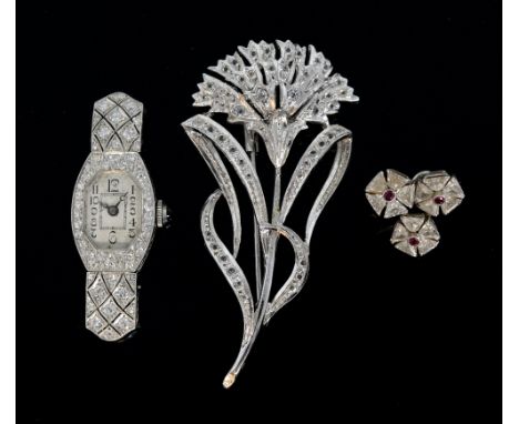 Art Deco cocktail watch set with sapphires, a single diamond and ruby cluster earring and a silver flower brooch.