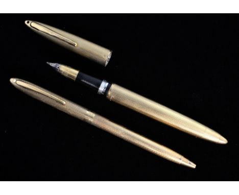 Two gold Sheaffer pens, both with engine turned decoration and 9 ct gold case, fountain pen with 14 ct gold knib 