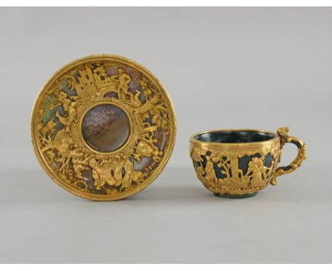 19th century continental green and mottled hardstone and gold overlaid cup and saucer, the gold overlaid decoration in the fo