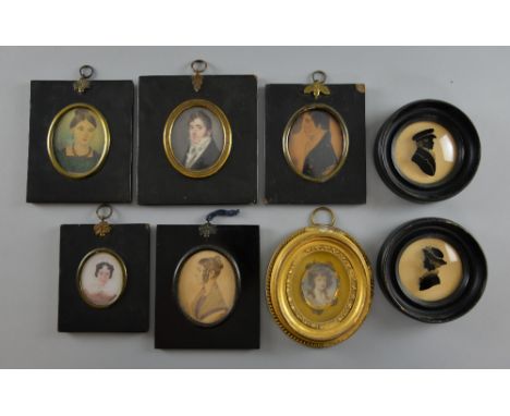 Oval miniature portrait of a Georgian gentleman, a similar portrait of a lady in a gilt frame, four other miniatures in black
