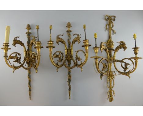 Pair of ormolu two-light wall sconces with ram's head decoration, and another similar,