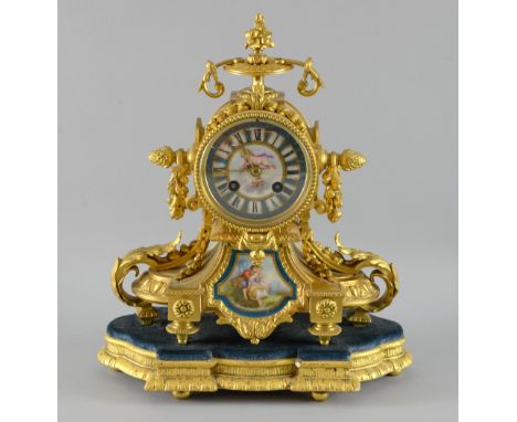 19th Century gilt metal eight day mantel clock, decorated with Sevres style porcelain mounts depicting a couple in a romantic