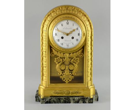 Gilt metal twin-train mantel clock striking on a bell, with foliate and scrolling decoration, the white enamelled dial with R