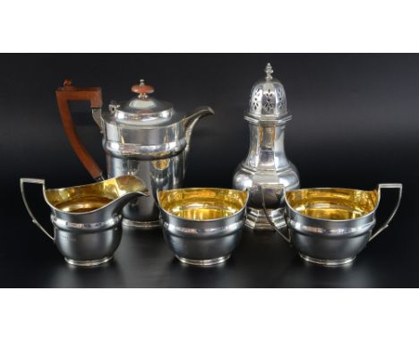 George VI silver four piece part tea service of oval section, comprising hotwater jug, cream jug, sugar bowl and another bowl