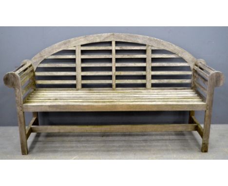 Teak garden bench after Sir Edwin Lutyen's design with a shaped arched back, 180cm wide,