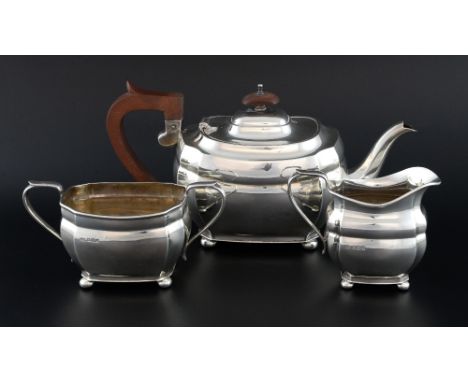 Modern silver three piece tea service comprising teapot, cream jug and sugar bowl, each on four bun feet, by Roberts & Belk, 