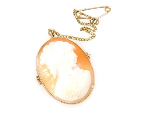 A 9ct gold oval cameo pendant, bust portrait of a lady, on a safety chain as fitted, 4.3g.