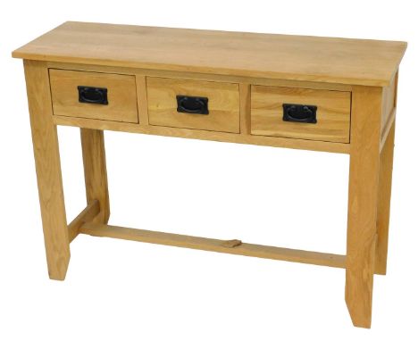 A light oak side table, with three frieze drawers, on stiles, 78cm high, 110cm wide. 