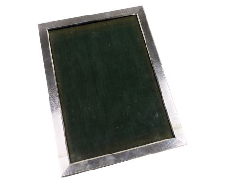 A George V silver strut photograph frame, with engine turned decoration, Birmingham 1929, 31cm x 22cm.
