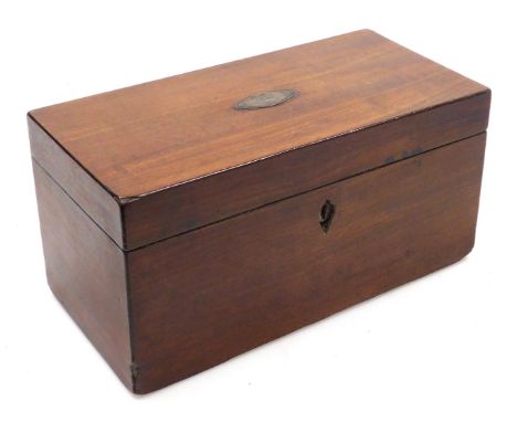 A Georgian mahogany tea caddy of rectangular section, the hinged lid opening to reveal a pair of lidded compartments, flankin