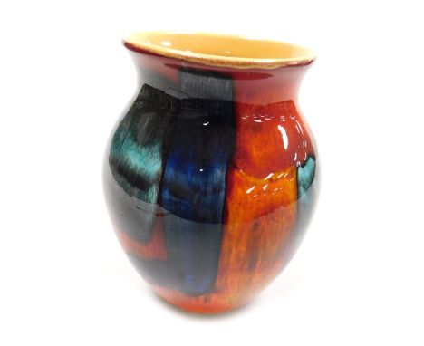 A Poole Pottery Galaxy vase, decorated in tones of blue, orange and red, raised marks, 20.5cm high.