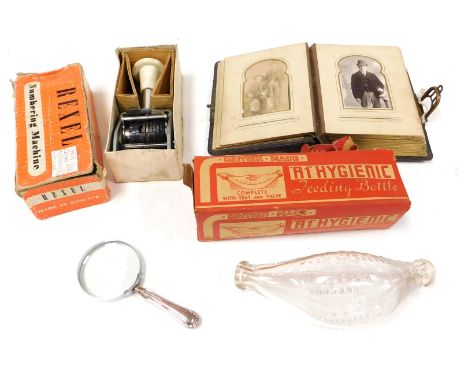 A Rexel numbering machine, A1 hygiene feeding bottle, magnifying glass with silver handle, Sheffield 1918, and a Victorian al