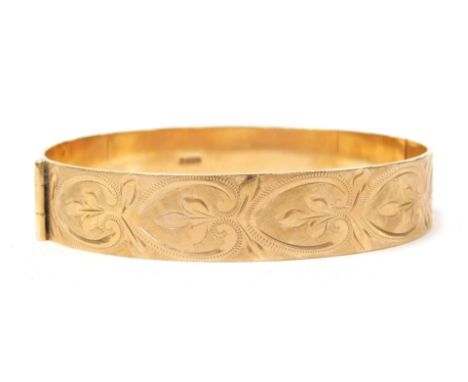 A 9ct gold bangle, with engraved repeating acanthus leaf decoration, on a snap clasp, 24.5g.