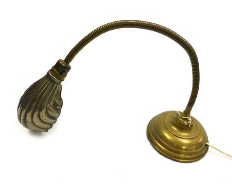 An early 20thC brass anglepoise desk lamp, with a fluted shell shaped shade, on a loaded base.Buyer Note: WARNING! This lot c