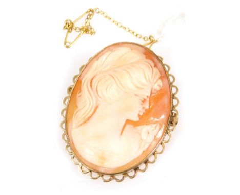 A 9ct gold and shell cameo brooch, bust portrait of a lady in an oval frame, with safety pin as fitted.