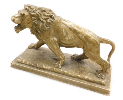 After Antoine Louis Barye (French, 1795-1875). Gilt plaster model of a walking lion, raised on a rectangular base, 36cm wide.