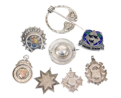 Victorian and later silver brooches and medallions, including a silver and enamel buckle with moto "Lauda Finem", a Celtic br