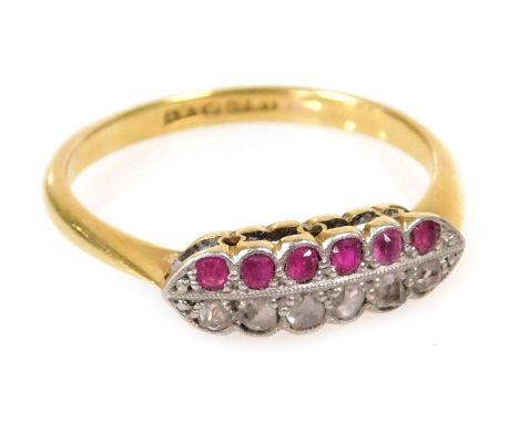 A ruby and diamond twelve stone ring, set with a row of each stone, in white and yellow metal, stamped plat and 18ct, size O,