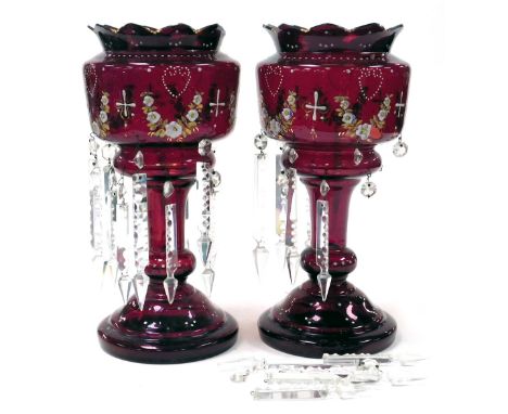 A pair of late 19thC ruby glass lustres, with enamel decoration of floral swags, with prismatic clear glass drops, 37cm high.
